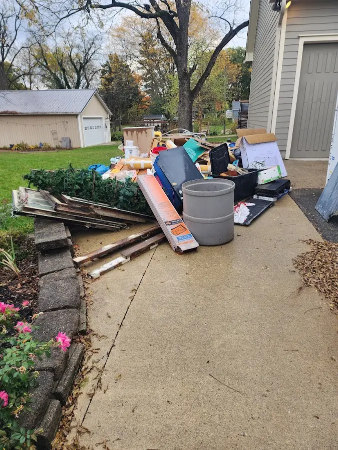 Dumpster being loaded with debris for Estate Cleanout Dumpster Rental in Gilmanton